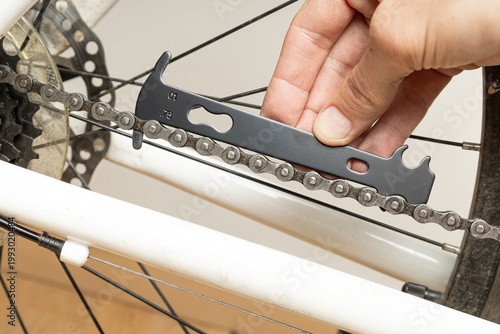 Worn bicycle chain. A tool for measuring chain tension
