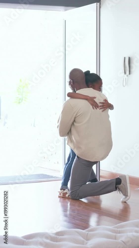 Vertical video: Opening front door, father kneeling hugging daughter coming home, placing backpack