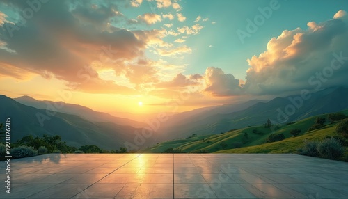 Empty square terrace overlooks green rolling hills with sunlit mountains beyond. Golden sunset clouds paint sky with warm hues. Vast landscape view offers serene, open space for contemplation travel