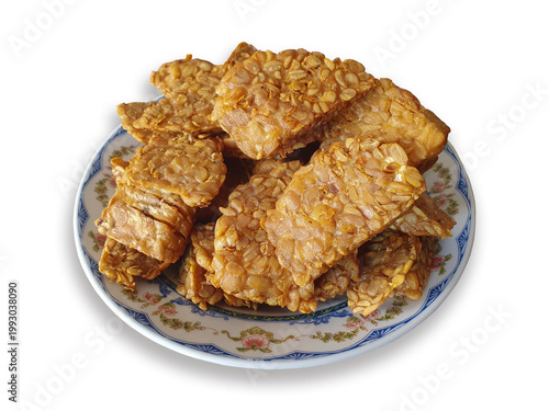 Fotografia Fried tempeh slices on floral plate, delicious savory fried tempeh high protein