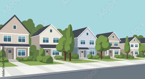 Suburban street with row of detached houses and green trees under clear sky