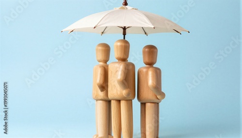 Three wooden figures under an umbrella representing protection and security