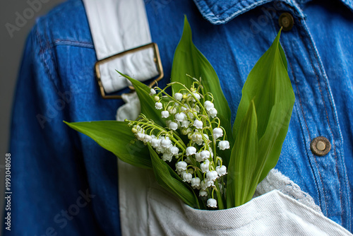 Fresh White Lily of the Valley in Workwear Pocket, Rustic Spring Floral Background
