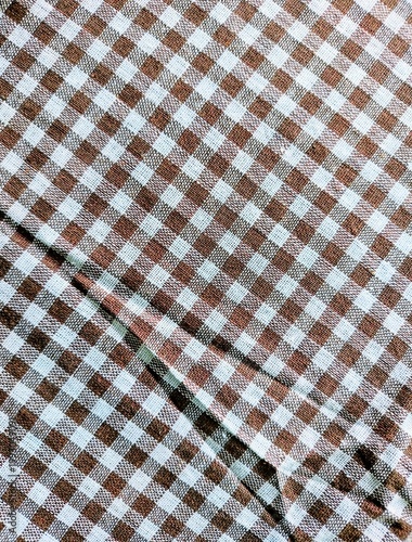 Brown and white gingham fabric texture background, seamless checkered pattern textile for picnic tablecloth, rustic cotton material cloth for fashion apparel and interior design mockup.