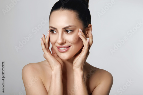 Happy Beautiful Girl Holding Her Cheeks With A Laugh Looking To The Side. Pretty Woman Clean Fresh Skin.Cosmetology, Beauty And Spa.