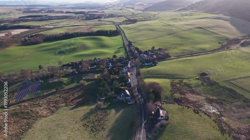 Traditional Scottish village of Silverburn nestled at the foot of the majestic Pentland Hills surrounded by green fields and rural roads