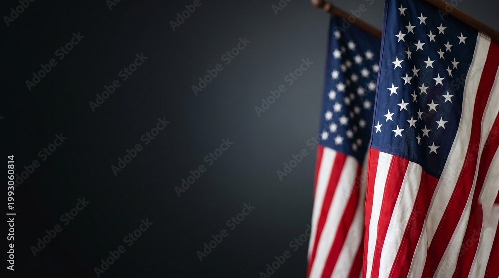 Obraz premium Two American flags with stars and stripes are displayed vertically against a dark background offering ample copy space