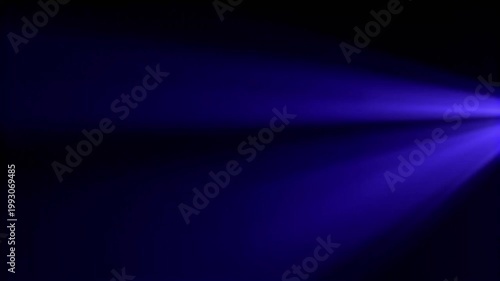 Vibrant blue stage light beam cutting through black background for event backdrop