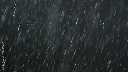 Heavy rain falling during a dark storm creates a moody motion blurred texture