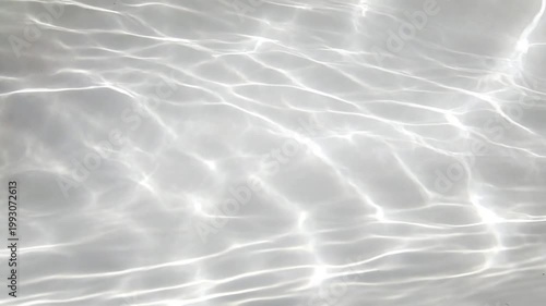 Abstract Ripple Reflection: Captivating patterns of light dance across a serene surface, a symphony of gentle waves. The play of light and shadow creates an ethereal visual experience.