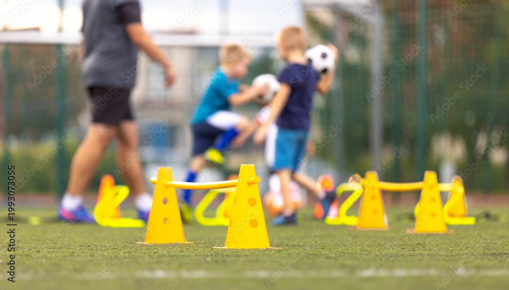 Obraz premium Soccer Football Training Session for Kids. Boys Training Football on the Pitch. Soccer Stadium in the Background. Young Soccer Boys Improving Strength and Agility Skills Outdoor