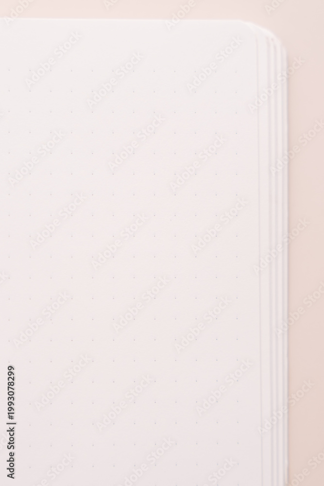 Naklejka premium Blank notebook page close up on soft beige background.