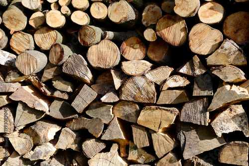 Stack of split firewood logs for winter heating, rustic wood pile