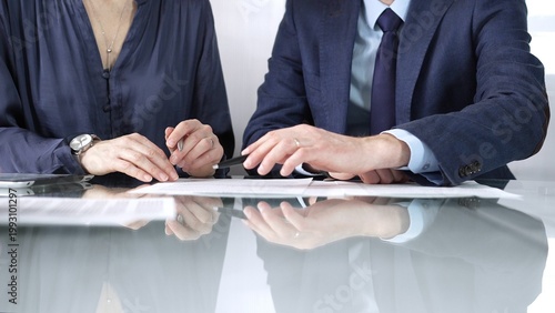 Tableau sur toile Business partners or lawyers are discussing contract papers during a meeting, negotiating and making decisions together