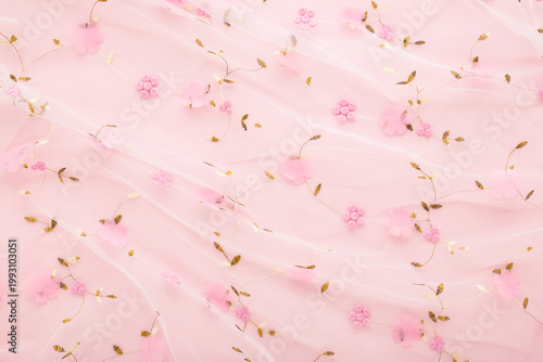 Cuadro en lienzo New transparent soft wrinkled tulle fabric with flower pattern on light pink table background