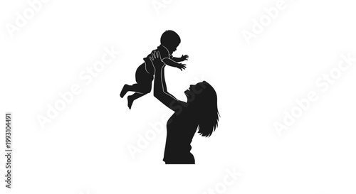 Mother tossing baby in the air silhouette