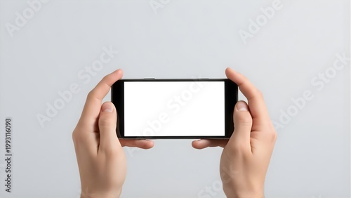 Hands holding smartphone with blank white screen mockup landscape