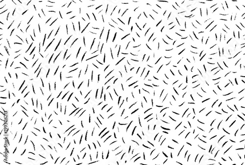 Abstract hand drawn scattered short lines pattern. Black and white grunge dashes texture. Messy ink strokes doodle background vector illustration.