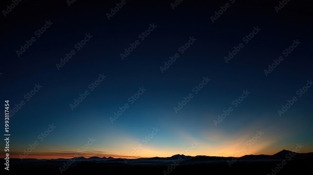 Fototapeta premium predawn. Golden rays of dawn breaking over the horizon into a deep blue pre-dawn sky. travel magazines, destination branding, designed for outdoor magazines and nature guides, used by ux designers.
