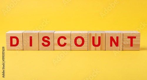 A wooden block arrangement spelling out the word DISCOUNT on a bright yellow background