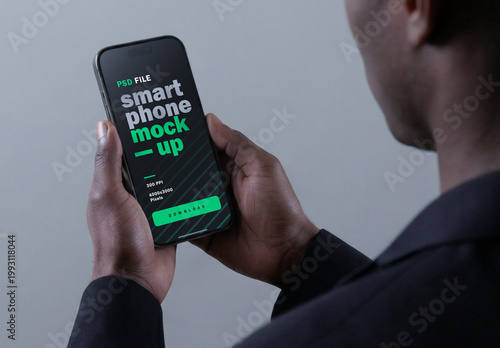 Cinematic Smartphone Mockup Held By Business Man With Gray Background