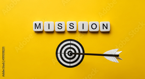 A bullseye target with an arrow and the word mission on a bright yellow background