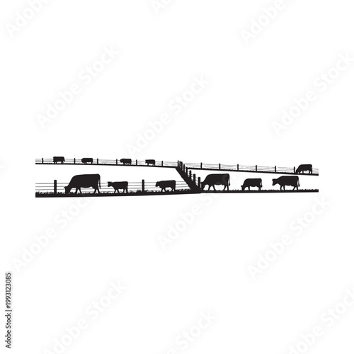 Silhouette of cattle grazing behind a wooden fence on a hillside