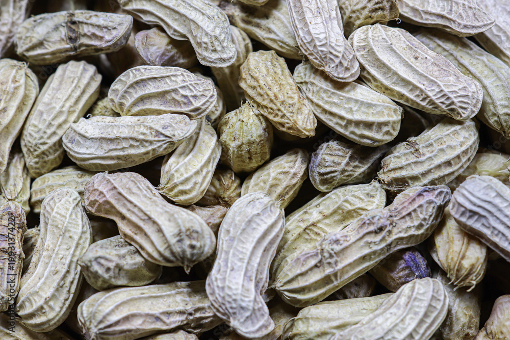 Fototapeta premium Top view boiled peanuts in shell, natural texture background, plant based snack concept with rustic look, healthy street food and organic lifestyle imagery.