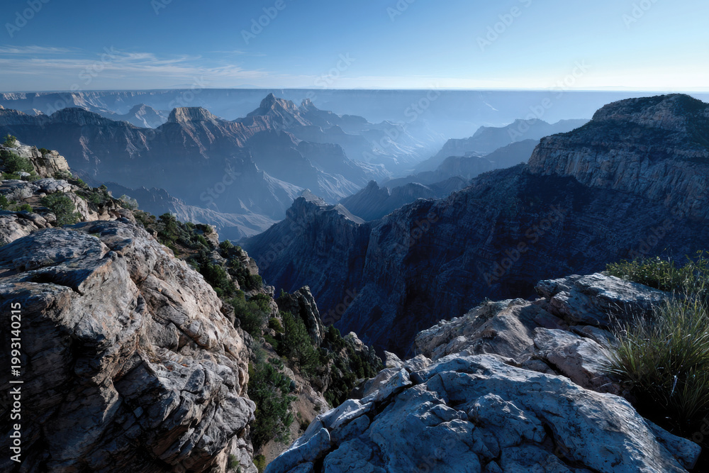 Fototapeta premium An expansive view from a rocky outcrop captures the vastness and beauty of undulating mountain ranges, inspiring a sense of adventure and wonder.
