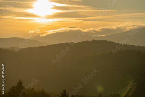 The peak of Babia Gora in the clouds just before sunset.