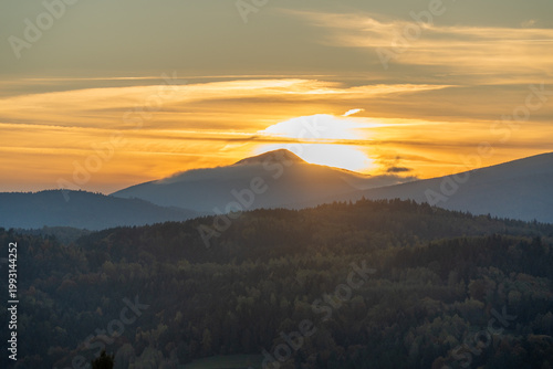 The peak of Babia Gora against the backdrop of the setting sun in autumn.