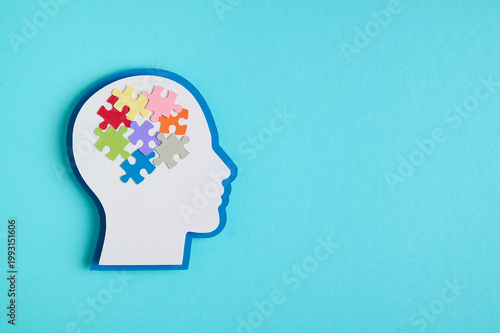 Mental health concept featuring a head silhouette and a puzzle inside