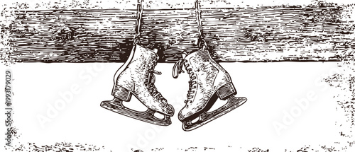 Vintage ice skates hanging on a wooden beam with grunge textured background in rustic