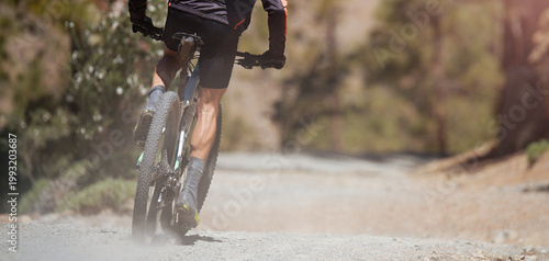 Mountain biking man riding on bike in summer mountains forest landscape. Sport fitness motivation and inspiration in beautiful inspirational landscape