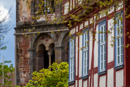Historic half-timbered town house in front of the Katharinenturm (Catherine's tower) of the monastery ruins in the spa town of Bad Hersfeld, Hesse, Germany