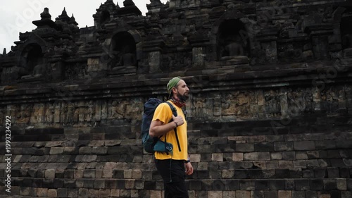 Man walking through Borobudur Temple, cinematic spiritual journey