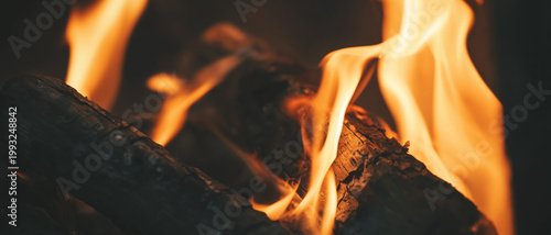 Closeup panoramic view of burning fire in a stone fireplace