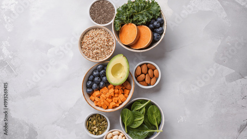 Assorted superfoods arranged in bowls, clean eating concept, neutral background