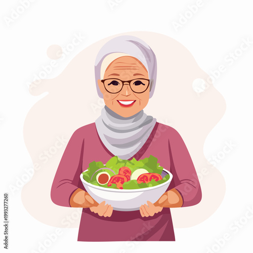 Smiling elderly woman in hijab holding a fresh salad bowl