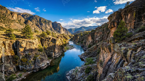 A majestic mountain canyon with a river winding