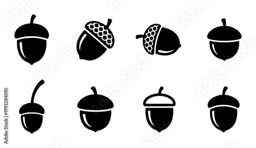 Minimalist acorn icon set, black oak nut silhouettes, 8 nature vector elements, autumn forest seed symbols for seasonal branding and logo design