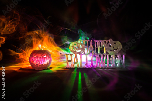 Halloween concept. Creepy silhouette in the dark corridor with pumpkin head. Toned light with fog on background.