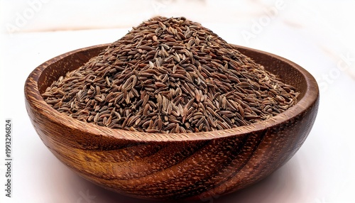 cumin seeds in wooden bowl a close up view of a wooden bowl overflowing with whole cumin seeds their earthy aroma and rich flavor enhance countless culinary creations