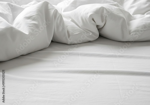 Disheveled white bedding and rumpled sheets create a soft, inviting scene.