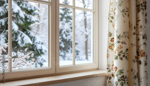 Cozy interior window with floral curtains and snowy forest view.