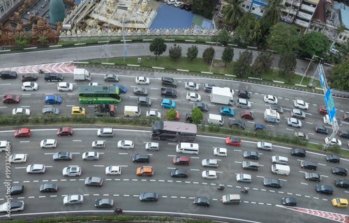 Photography Aerial view of busy highway traffic in Kuala Lumpur, Malaysia, with dense urban