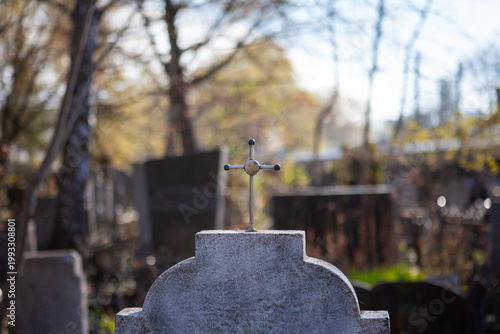 Tombstone with a cross in an old cemetery