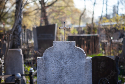 Tombstone with a cross in an old cemetery