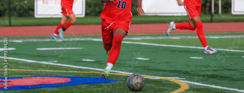 Youth Soccer Player Chasing the Ball on Field During a Game