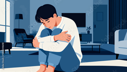 Blue-toned room, lone figure hugging knees